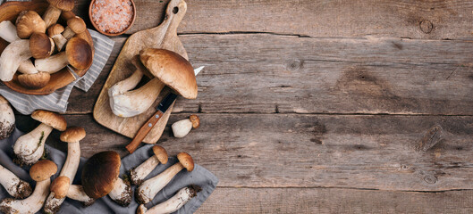 Fresh forest boletus mushrooms on wooden background. Top view. Copy space. Autumn harvest concept....