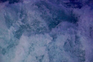 Footprint on the water after the ship. Bubbling water texture. The boiling ocean waves from the ship