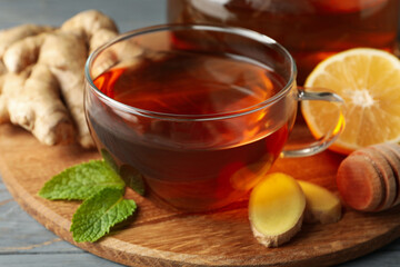 Concept of breakfast with ginger tea on wooden background