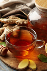 Concept of breakfast with ginger tea on wooden background