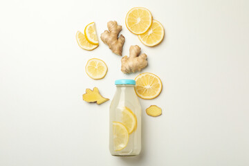 Bottle of ginger lemon water on white background