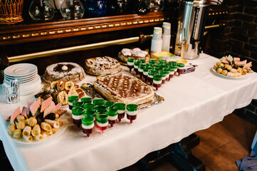 Sweet table. Table with sweets, candy, buffet. Dessert table for a party goodies. Close up. party reception, decorated in restaurant. candy bar.