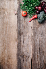 Copper pot, herbs, purple onion, pumpkin, tomato, broccoli, pepper, cabbage, carrot, parsley, calafior, zucchini on wooden background. Top view. Copy space. Banner. Autumn harvest food cooking concept