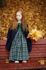 Irish little red haired girl laughing outdoor photo on fall landscape backgroun