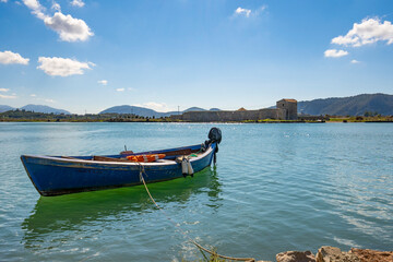 Fototapeta na wymiar fishing boat on the lake with fortress