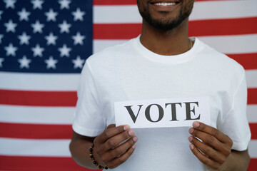 Black man with voting card