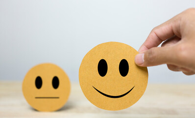 Fototapeta premium Hand choosing happy smile face paper cut for feedback review , Customer satisfaction concept 