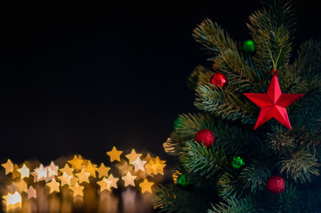 The star ornaments decorate on Christmas tree with star bokeh lights background. Christmas and New year concept.