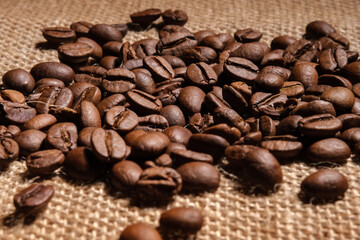Coffee beans are scattered on the cloth on the table.