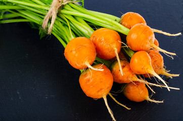 Bunch of fresh round carrots, organic vegetables, vegetarian food. © ArtCookStudio