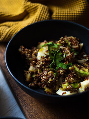 Avocado, egg, quinoa curry salad. Whole foods home made on rustic farm table in natural light