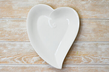 White ceramic plate shape heart top view minimalism copy space