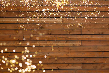 Golden bokeh lights with wooden background