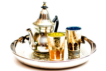 Group of teapot and glasses of oriental tea on a tray on white background