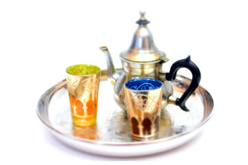 Group of teapot and glasses of oriental tea on a tray on white background