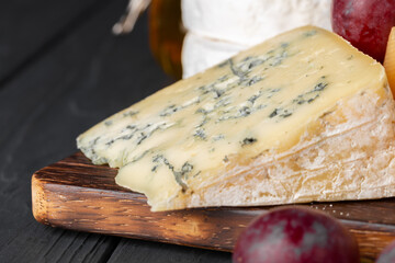 Close up photo of cut cheese and grapes