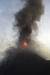 Fototapeta premium Camping with a view to a volcano eruption on Fuego and the active Volcan Acatenango in Guatemala