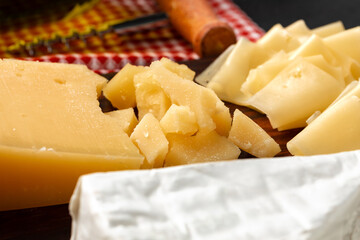 Cut pieces of hard cheese close up