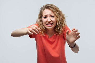 Image of dissatisfied girl doing disgust face because aversion reaction with hands raised. Facial...