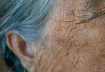 Wrinkled skin of the old woman