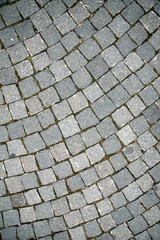 Abstract background of old cobblestone pavement close up.