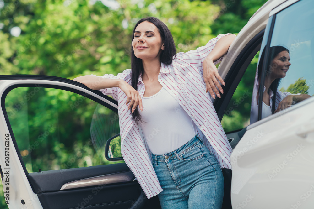 Sticker photo of positive cheerful girl tourist ride drive car outdoors town stop parking lot enjoy air wind