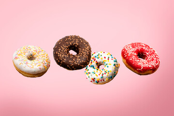 Donuts flying in the air on a pink background. Bakery, baking concept. Levitation. Banner