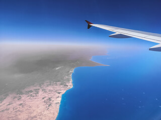 view to the blue sea and horizon at a flight