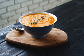 Homemade pumpkin soup on a black table