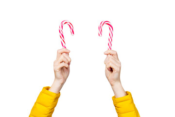 female hands holding two lolipop candies on a white background. Concept Christmas, New Year, Valentine's Day