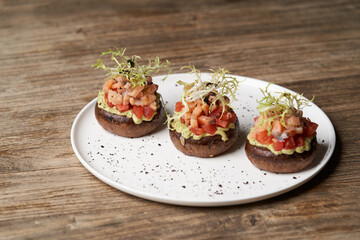 Salmon tartare with guacamole sauce, close-up