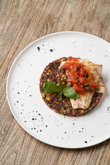 Sea bass fish with quinoa risotto. Sea bass with red quinoa, herb and vegetable salad