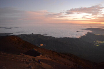 Sunrise hiking and camping on the active Volcan Acatenango with a view to the volcano Fuego eruption - Guatemala