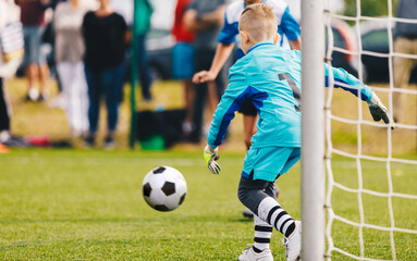 Boy Football Goalie in Action. Young Soccer Goalkeeper Running Towards Soccer Ball. Child Goalie Soccer Save on School Tournament