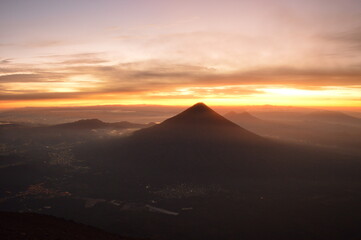 Sunrise hiking and camping on the active Volcan Acatenango with a view to the volcano Fuego eruption - Guatemala