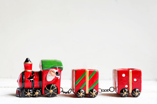 A photo of Santa in a christmas toy train on white background with copy space