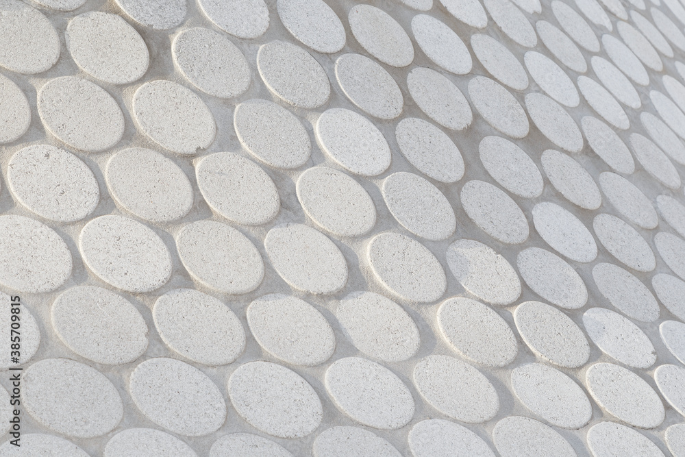 Poster close-up of abstract geometric white stone slab pattern on a sunny day. side view, focus on the fron
