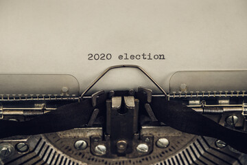 typing words 2020 election on a vintage typewriter close-up. old and grunge atmosphere