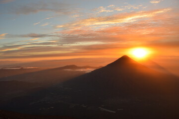 Sunrise hiking and camping on the top of the active Volcan Acatenango while the Volcano Fuego is erupting - Guatemala