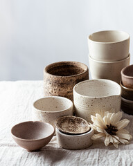 handmade ceramic tableware on light linen background