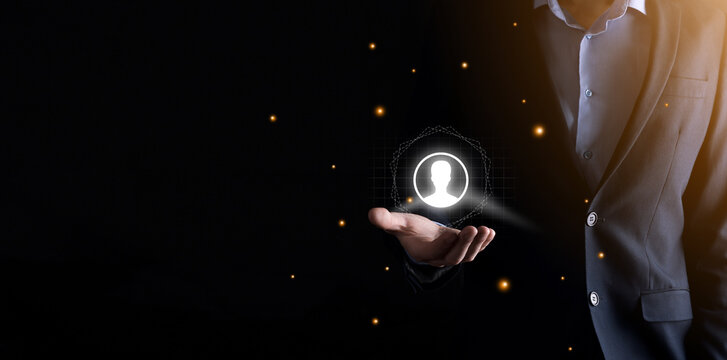 Businessman in suit holding out hand icon of user. Internet icons interface foreground. global network media concept,contact on virtual screens ,copy space.