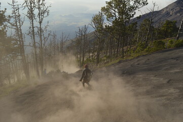 Sunrise hiking and camping on the top of the active Volcan Acatenango while the Volcano Fuego is...