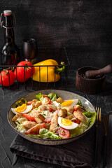  Caesar salad with chicken on the table vertical photo