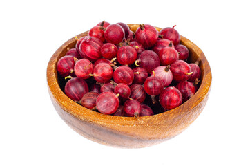 Fresh berries of red gooseberries in bowl on white background.