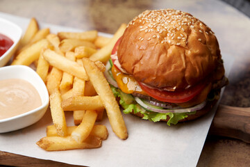 Cheeseburger with french fries and sauces