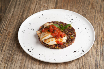 Sea bass fish with quinoa risotto. Sea bass with red quinoa, herb and vegetable salad
