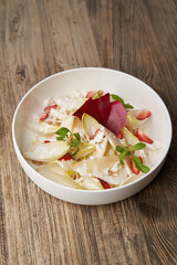 Endive salad with goat cheese, strawberry and walnuts.