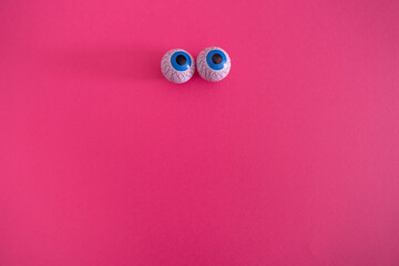 Two eyes on a pink background