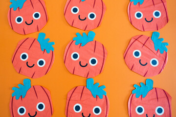 Lots of drawings of pumpkins with a orange background