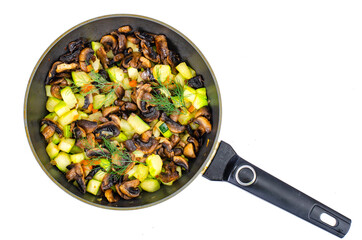Fried zucchini with mushrooms in pan. Photo